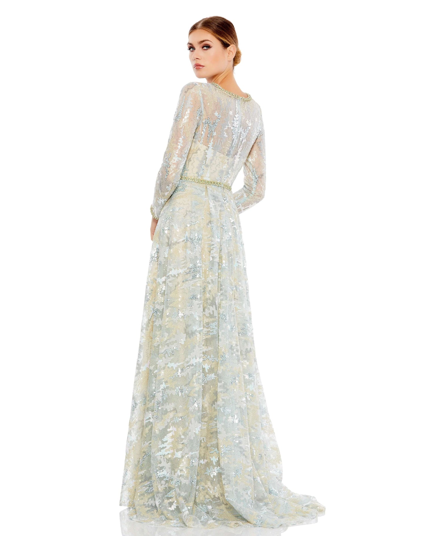This stunning illusion long sleeve A-line gown. The illusion overlay is embroidered and embellished with sequins and hand-beaded floral accents. The gown is finished with a a rhinestone embellished belt, neckline, and cuffs. Mac Duggal Unlined illusion yo