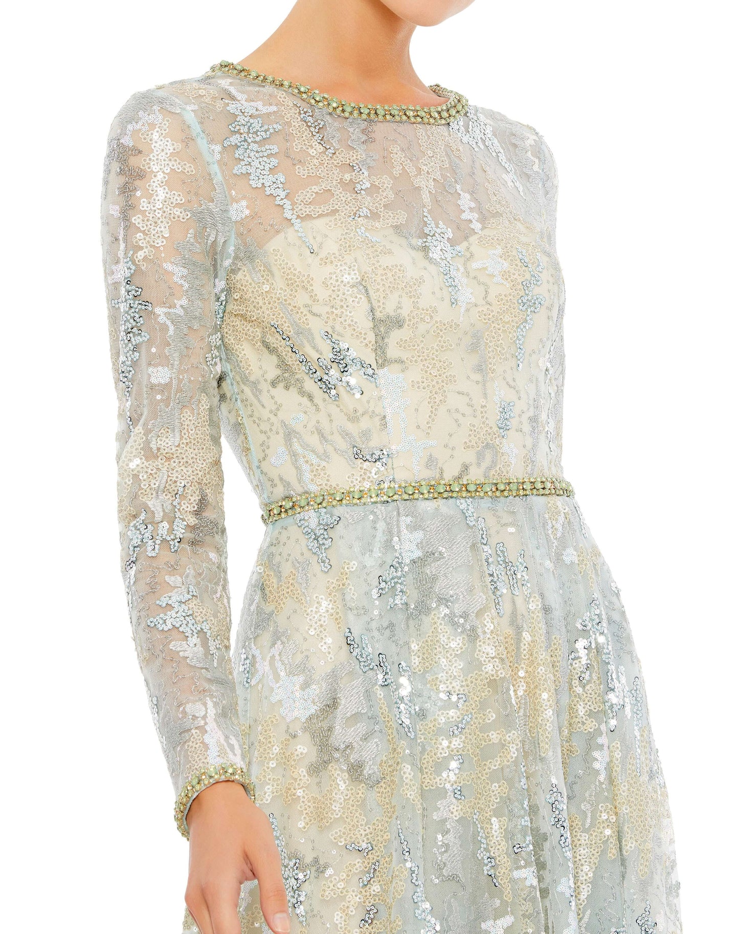 This stunning illusion long sleeve A-line gown. The illusion overlay is embroidered and embellished with sequins and hand-beaded floral accents. The gown is finished with a a rhinestone embellished belt, neckline, and cuffs. Mac Duggal Unlined illusion yo