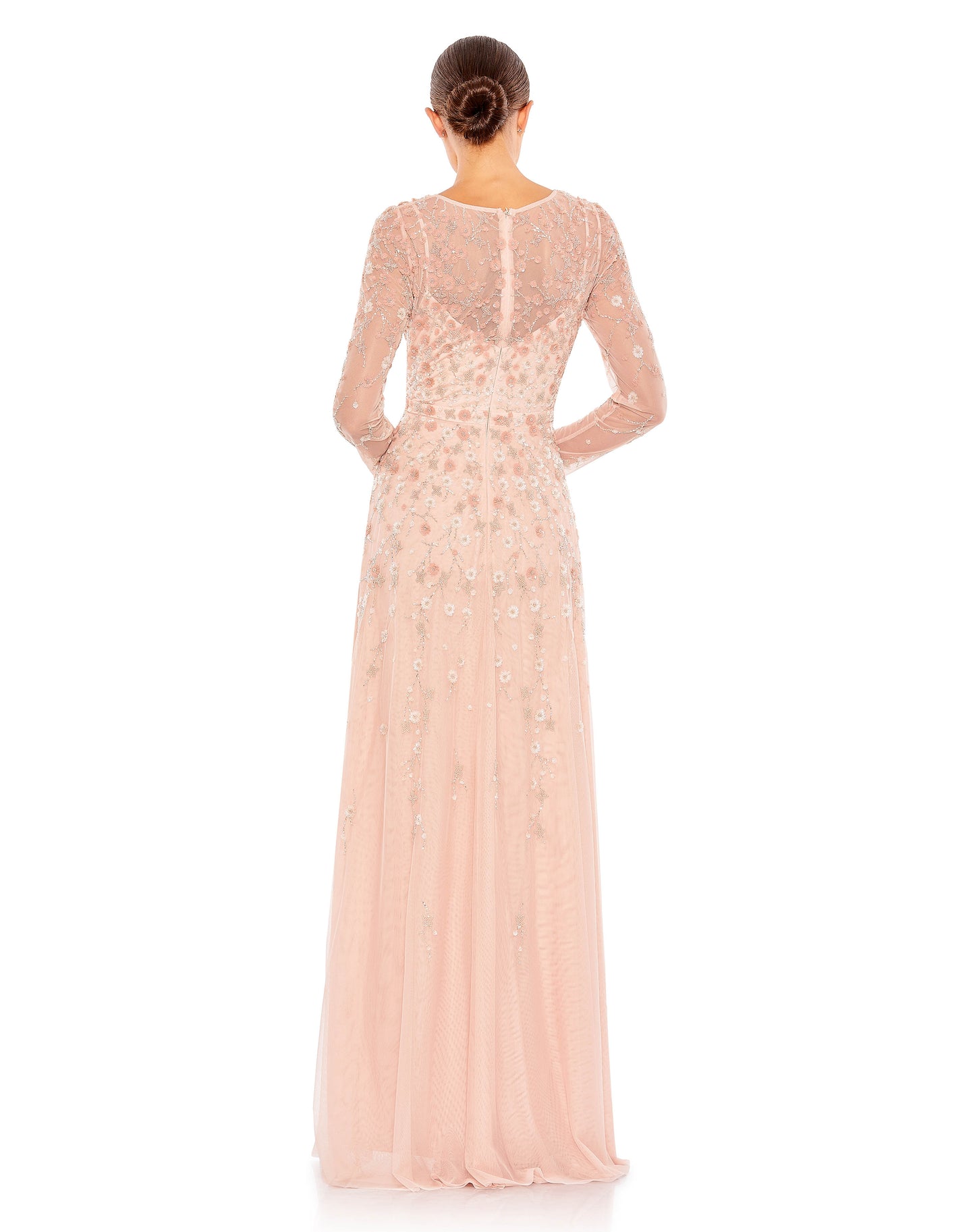 This gorgeous surplice gown is crafted with a sheer mesh overlay adorned with 3D floral embellishments across the bodice, arms, and skirt. With a v-neckline, sheer long sleeves, and a flowing skirt, this dress is an elegant choice for your next event. Mac