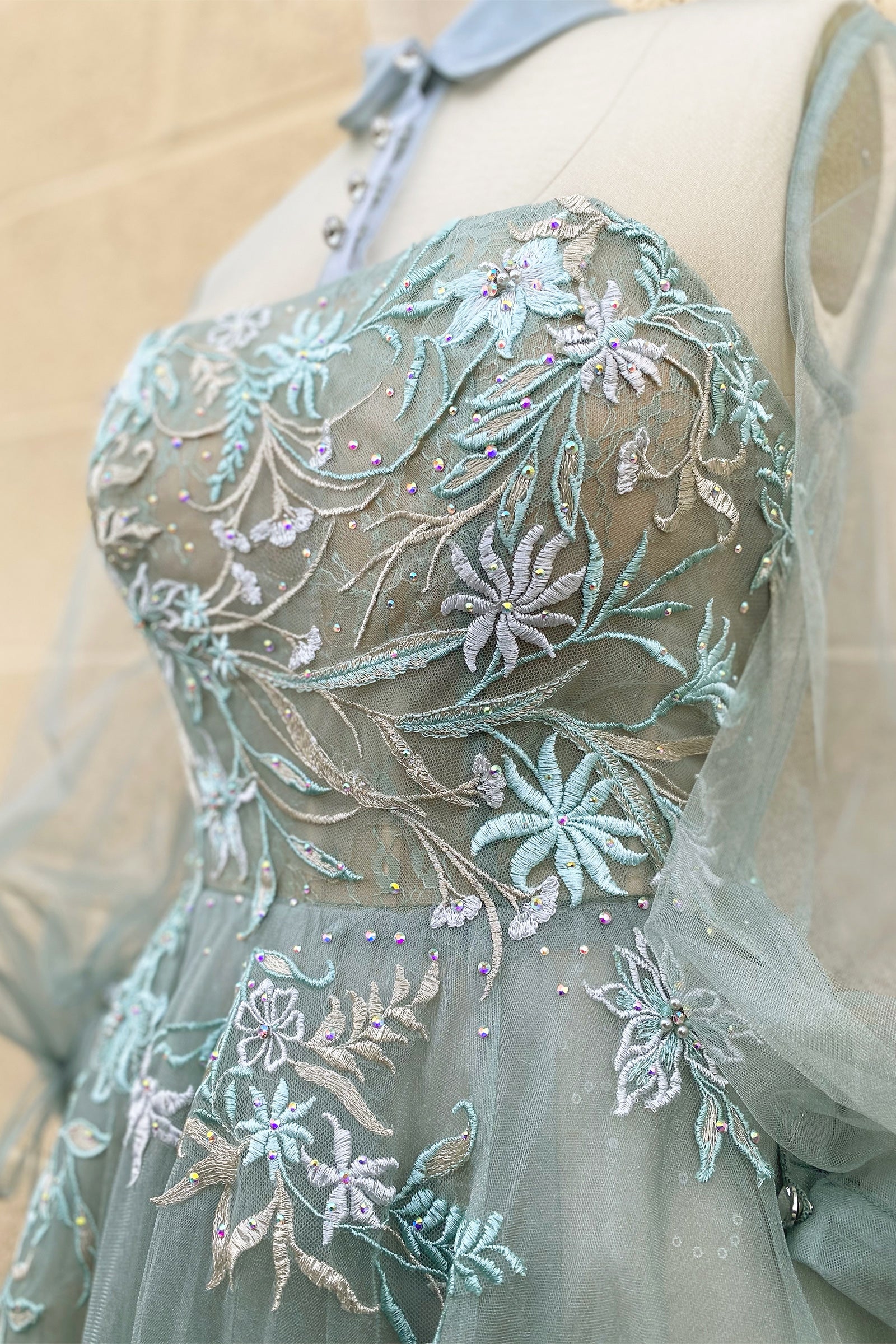 The Duchesa is perfectly appropriate for any special occasion. A fan favorite, this a-line cocktail dress in a beautiful pastel hue features a classic collar with an illusion yoke that connects to a corset-structured bodice overlayed with floral embroider