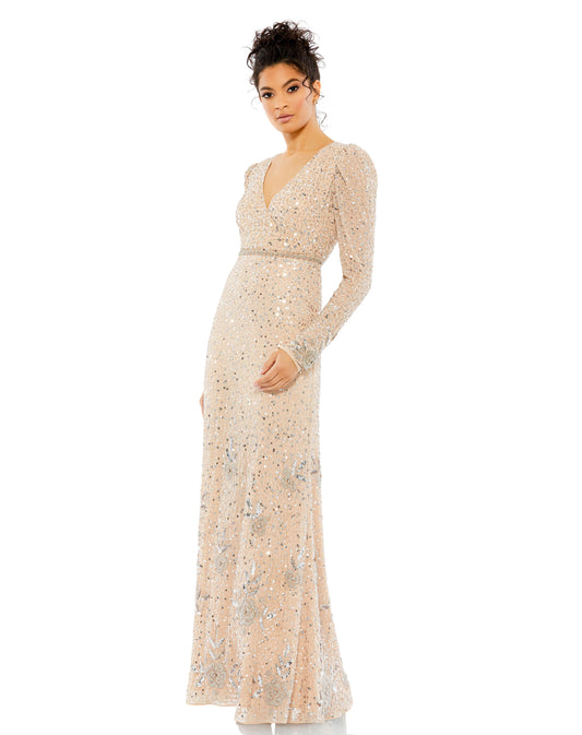 Make an entrance in this lovely embellished surplice gown. The chiffon overlay is embellished with an abstract pattern of beads and sequins through, and stunning floral beaded details grace the mid-skirt and hem. The long puff-shoulder sleeves feature bea