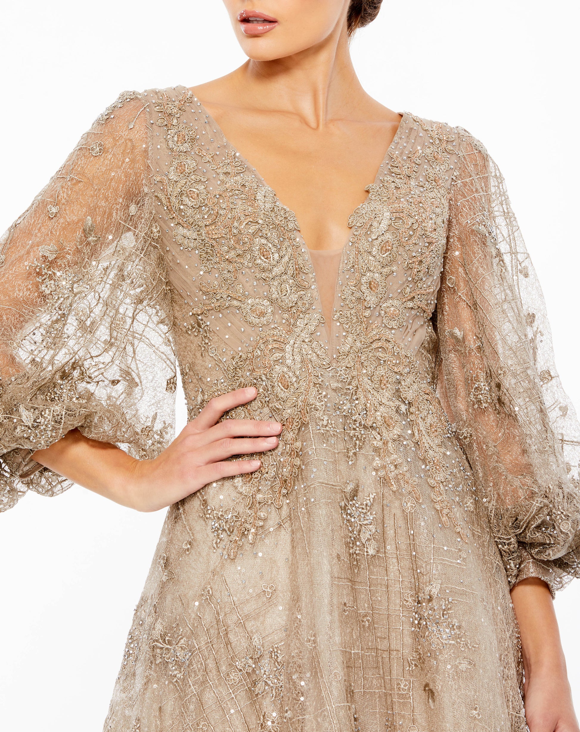 Mac Duggal Sheer sequin-embellished embroidered overlay; 100% polyester lining Partially lined bodice; fully lined through skirt; sheer unlined puff sleeves Plunging v-neckline Long puff sleeves All-over silver hand-sequined accents Mesh bust insert Sweep