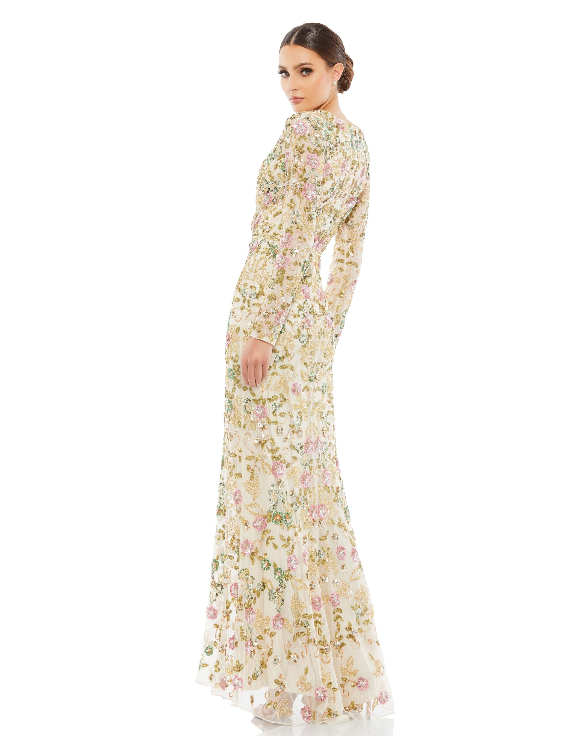 What is it about this gown we love so much? Everything. Embellished with a botanical-inspired pattern of sequins and beads, the dress is designed with a fitted silhouette, surplice neckline, pleated bodice, sheer long sleeves, and a flared hem punctuated