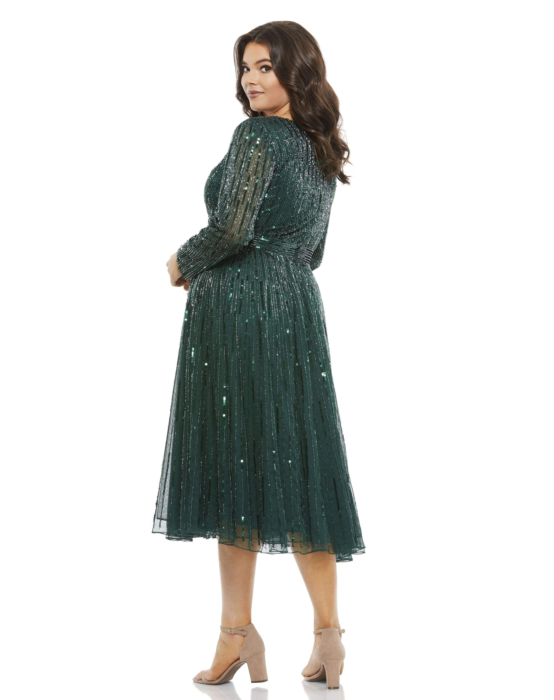 Fully embellished with vertical rows of tons sequins and beads, this dress brings the shine. The fitted bodice, sequined waistband, and flowing a-line skirt create an ultra-flattering silhouette, while the v-neckline and semi-sheer sleeves add a a bit of
