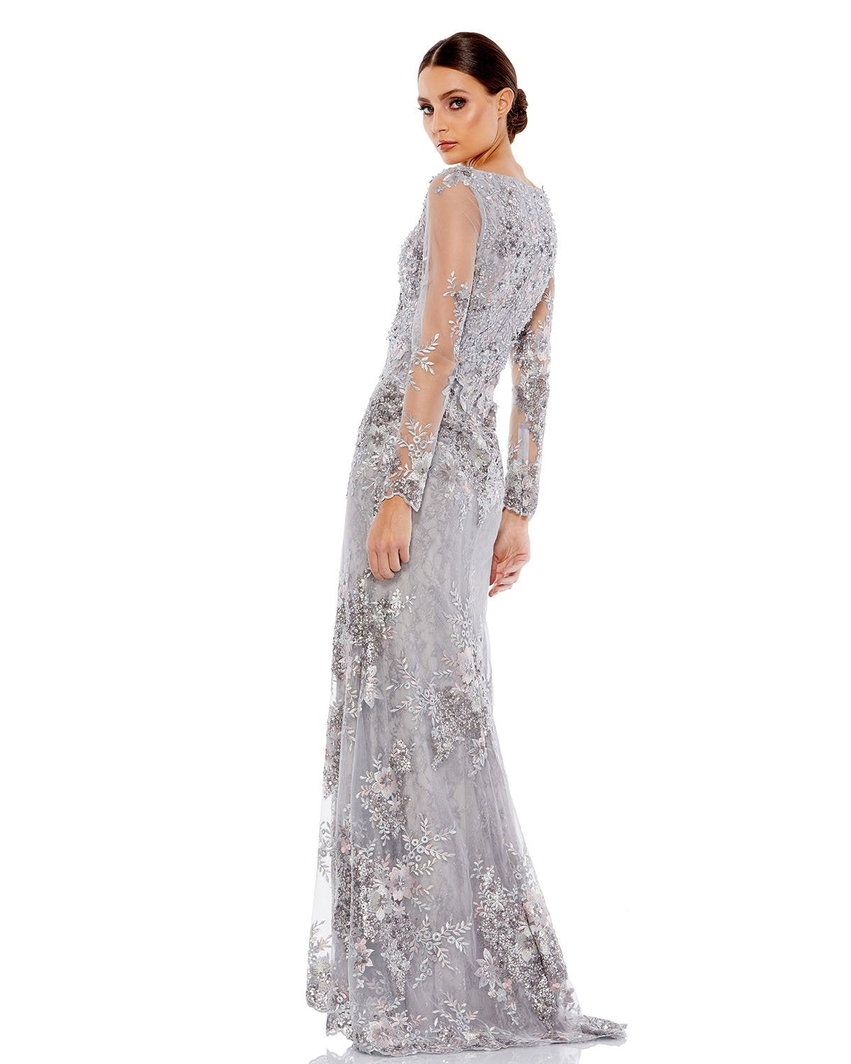 Elegant floor-length evening gown featuring illusion sleeves and plunging v-neckline. Gown adorned with floral embroidery and dainty beaded embellishments. Mac Duggal Back Zipper 100% Polyester Long Sleeve Full Length V-Neck Style #67539