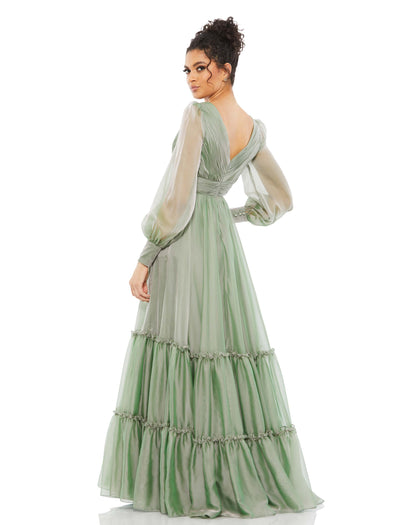 Romantic maxi dress with a pleated bodice and faux-wrap v-neckline, tiered floor-length skirt, and sheer long sleeves. Mac Duggal 100% Polyester Back Zipper V-Neck Long Sleeves Floor Length Style #67864