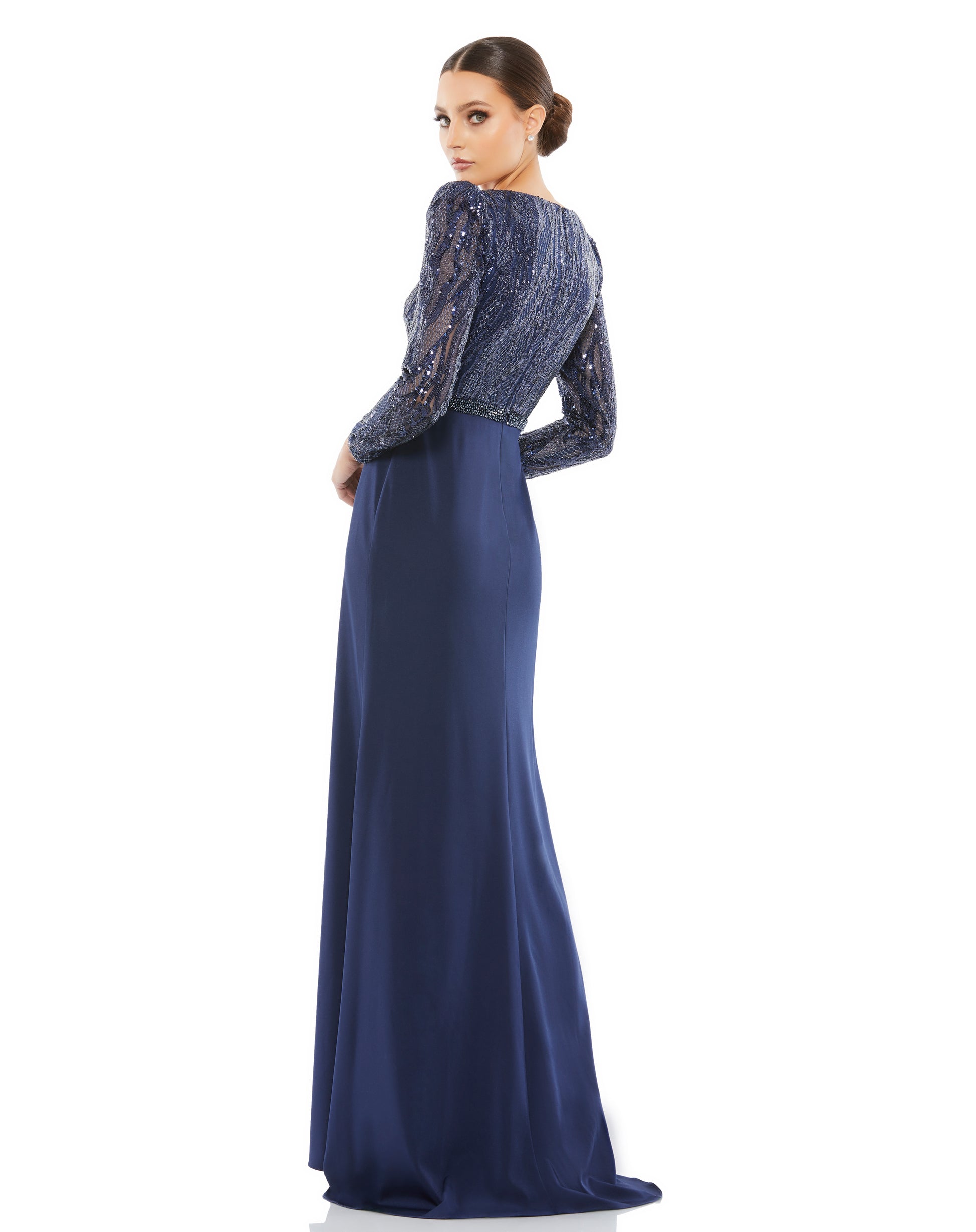 An elegant option for evening weddings and social events, this mixed-media gown is fashioned with a dramatic glittering embellished bodice offset by a sleek, minimalist crepe skirt. The dress opens with a modern V-neckline that perfectly frames a pendant,