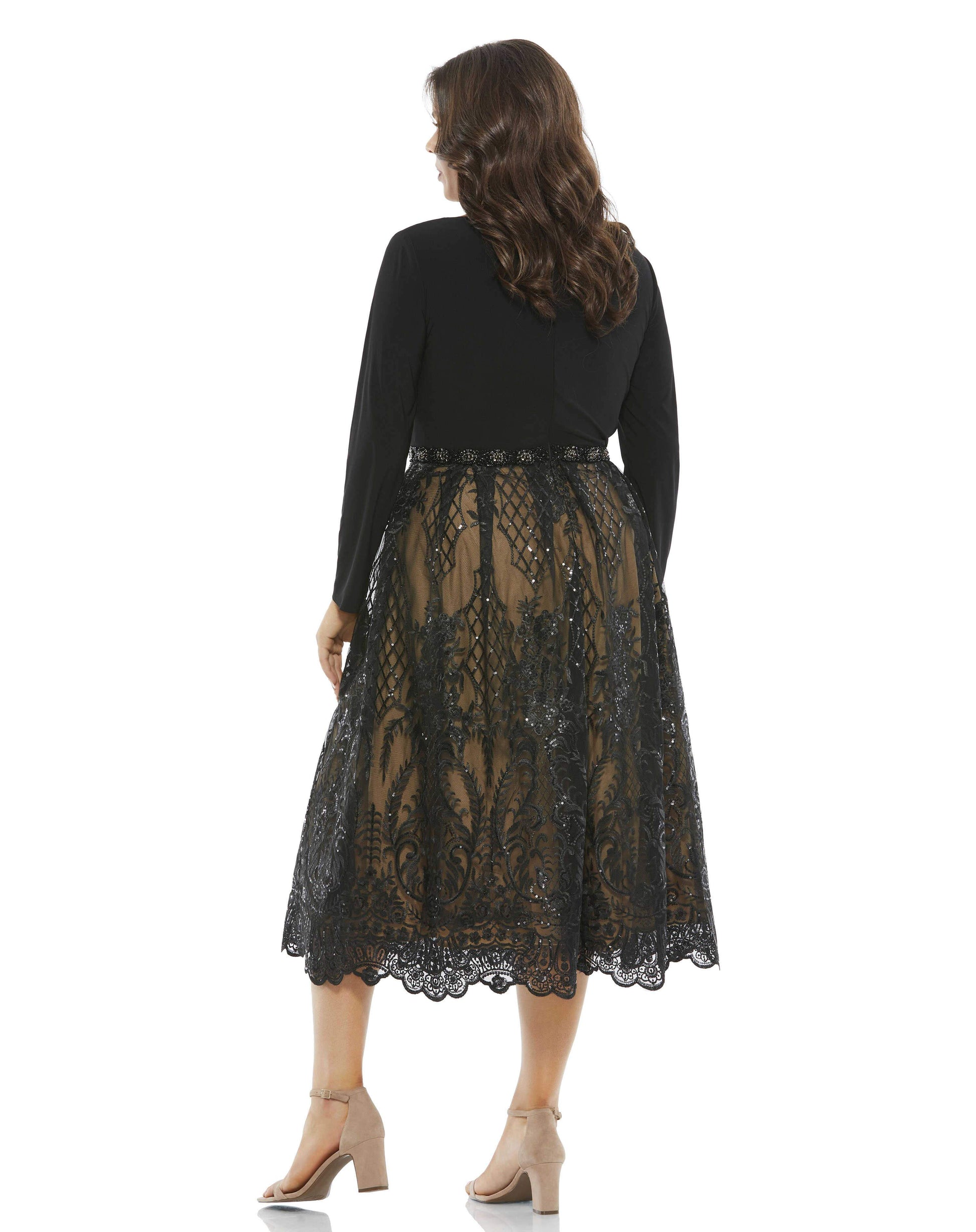 This chic cocktail dress makes a breathtaking look for special occasions. The mid-length dress opens with a minimalist jersey bodice cut with a pretty bateau neckline. An ornate beaded belt connects the top to an embroidered skirt stitched with lattices o