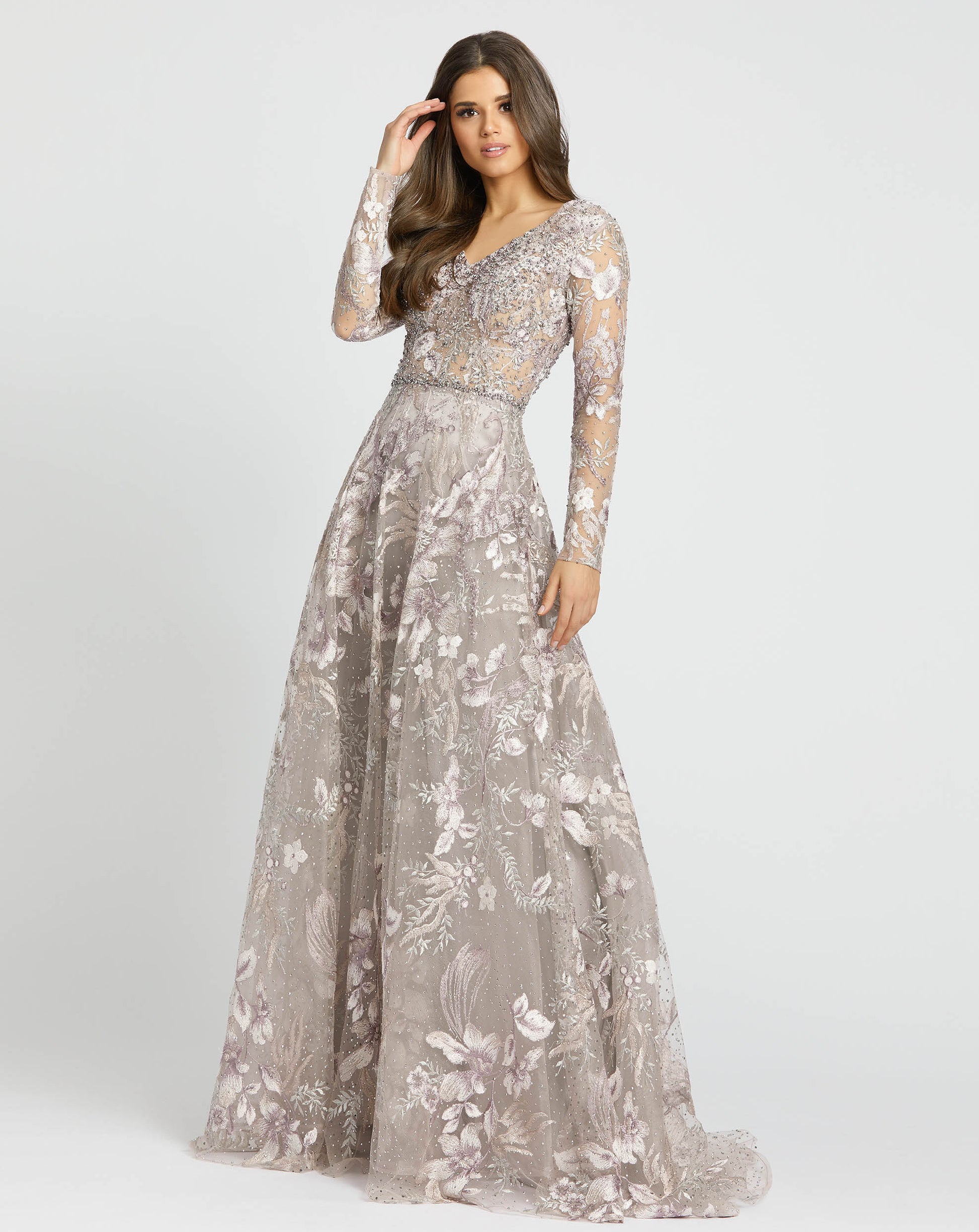 The bolder, the better. This jaw-dropping gown proves there’s no such thing as too ornate, flaunting an incredible design filled with botanical embroidery and dreamy crystal sparkle. The gown is styled with a V-neckline, sheer, embellished long sleeves an