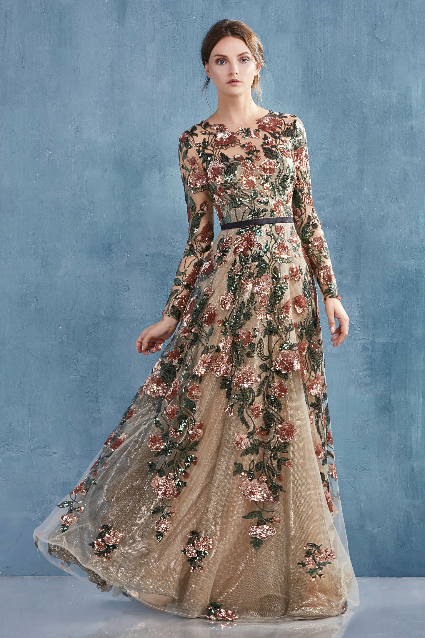 Savannah Gown features copper floral sequin motif that flows through the dress over metallic gold underlay. Ideal for ladies who is looking for fashionable long sleeve option, this gown provides coverage with sweetheart lining bodice then flares to soft A