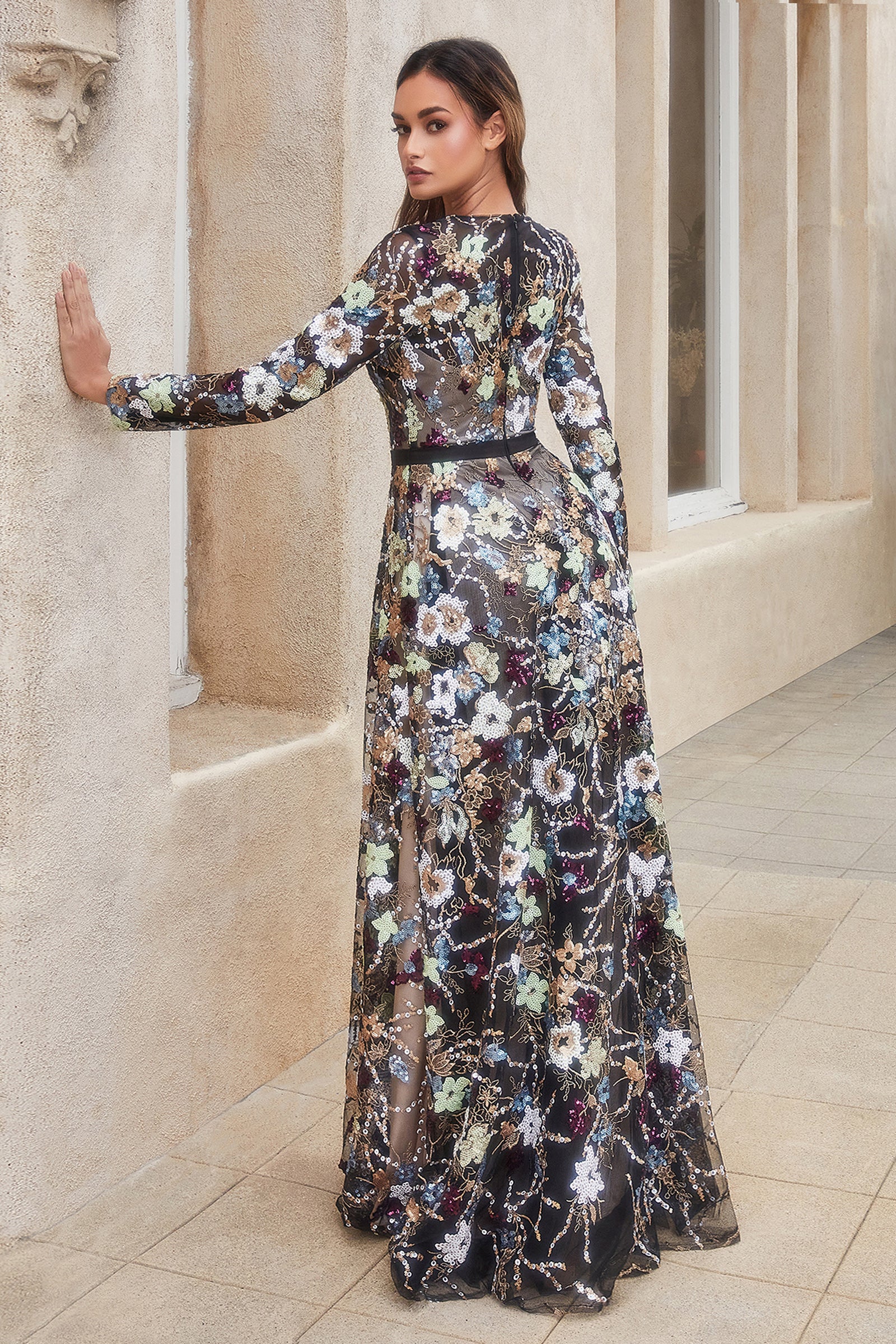 This dreamy dress features a tulle overlay covered in multicolored sequin print florals that evoke the beauty and serenity of a garden—the perfect look for any elegant event. The long sleeves add modest appeal, while the satin belt creates a flattering fi