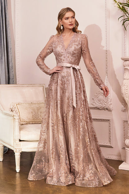 Make a grand entrance in this modest long sleeve gown. A shimmering glitter floral print adorns the fabric flowing from a lace scalloped v-neckline into an a-line layered skirt. The center back is closed with a zipper allowing for more coverage and wrist