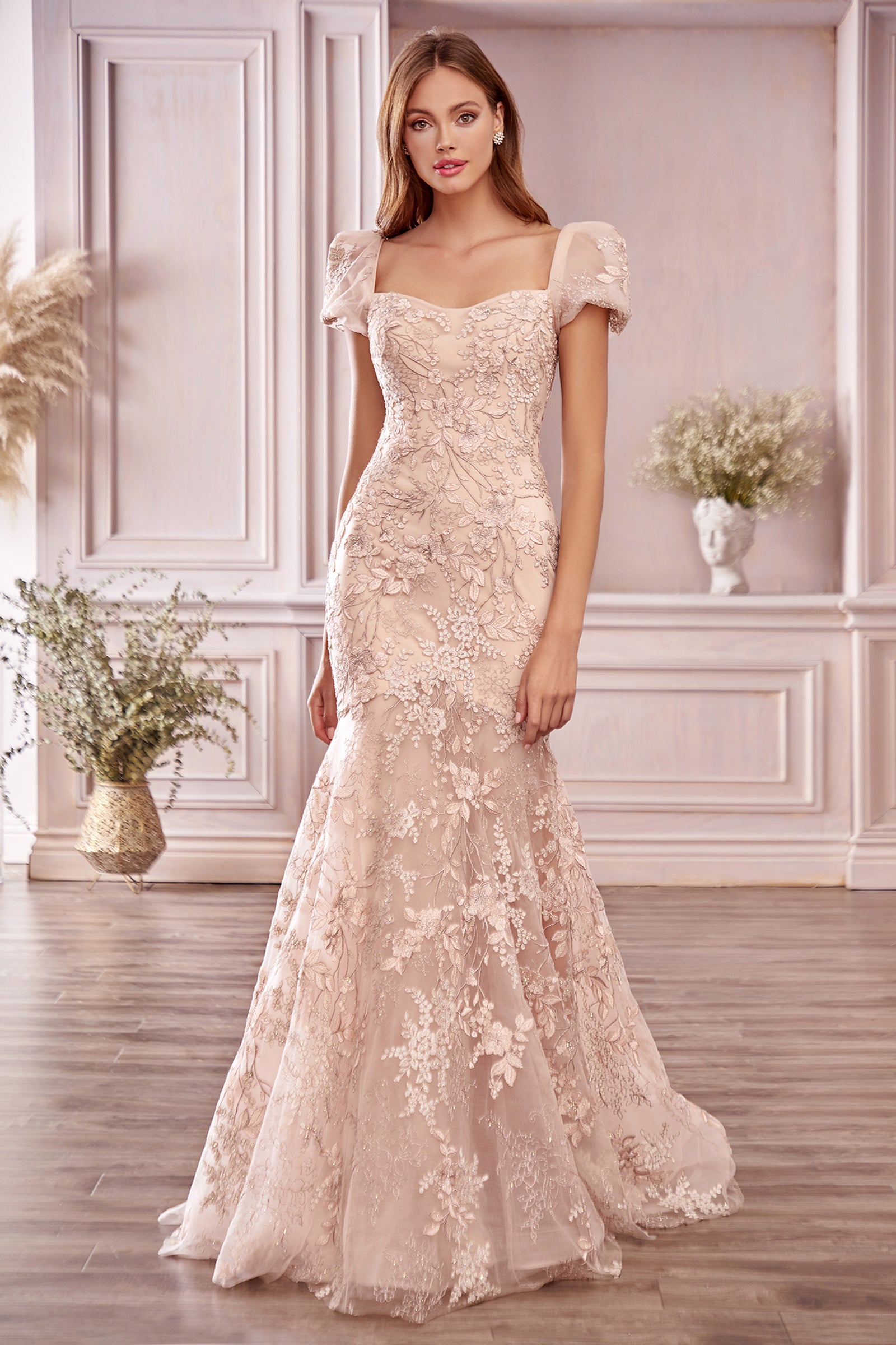 Blume Gown in soft blushing floral embroidery lace is inspired by an overgrown garden in spring. Romantic sweetheart neckline and sheer puff sleeve compliment the slim mermaid silhouette filled with silk thread florals. Slight stretch in the lining makes