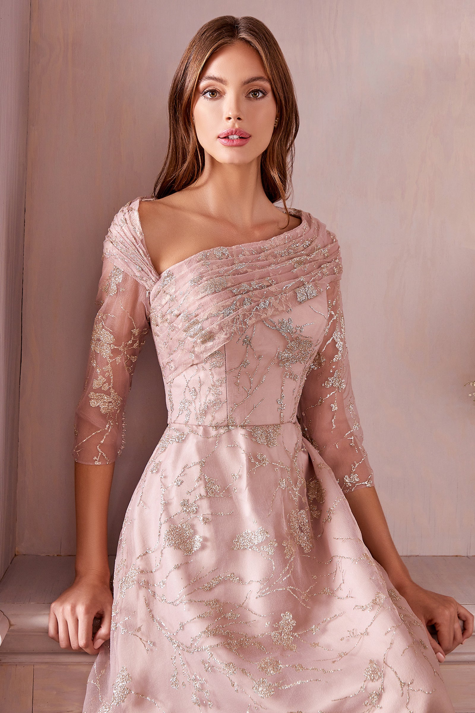 Sage and soft rose tones are trending for 2022. Golden Foliage Gown is the perfect Mother of the Bride/Groom dress that features gold metallic floral print on soft, muted pastel organza. This elegant A-line silhouette is soft and effortless. Three-quarter