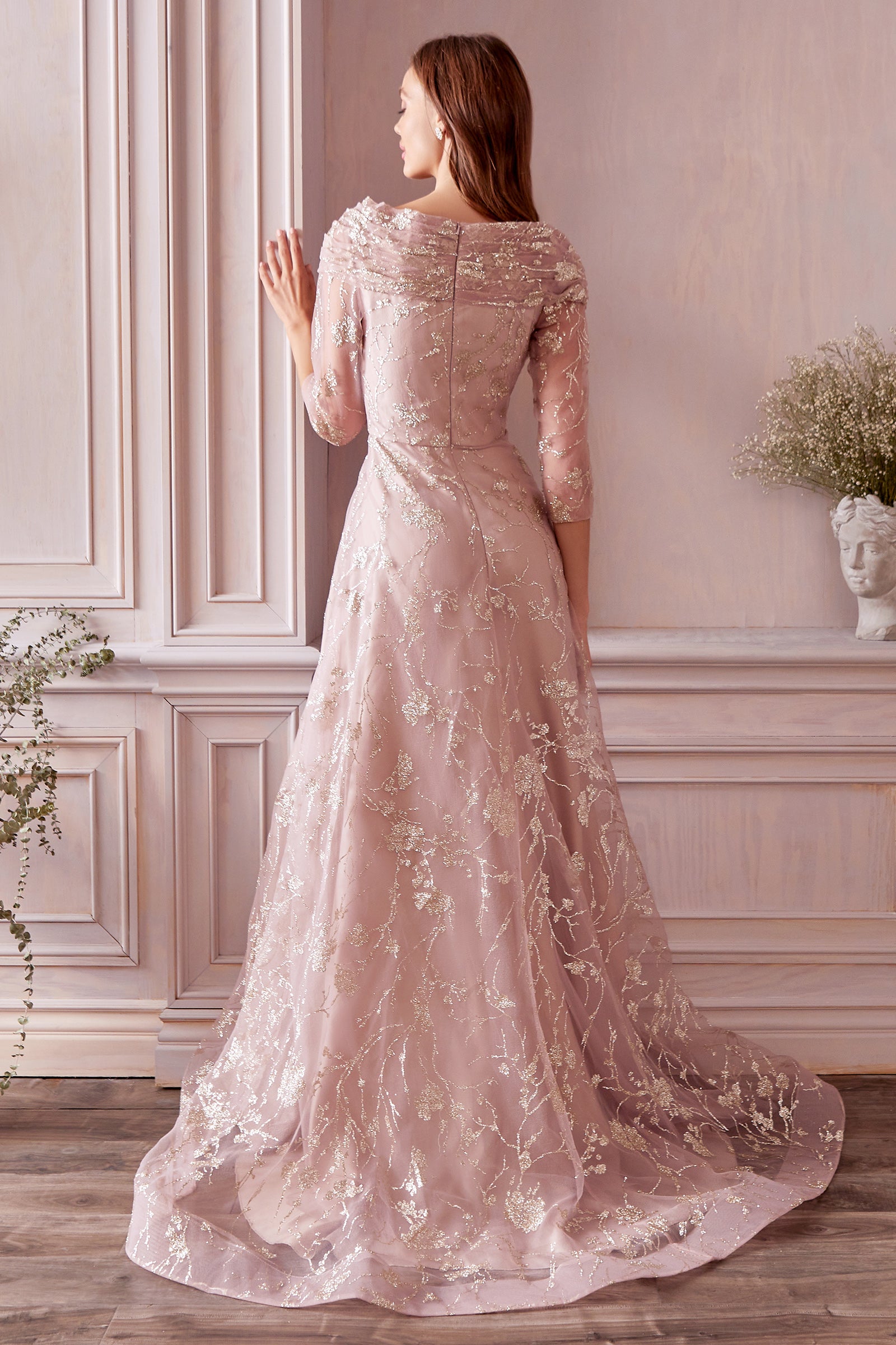 Sage and soft rose tones are trending for 2022. Golden Foliage Gown is the perfect Mother of the Bride/Groom dress that features gold metallic floral print on soft, muted pastel organza. This elegant A-line silhouette is soft and effortless. Three-quarter